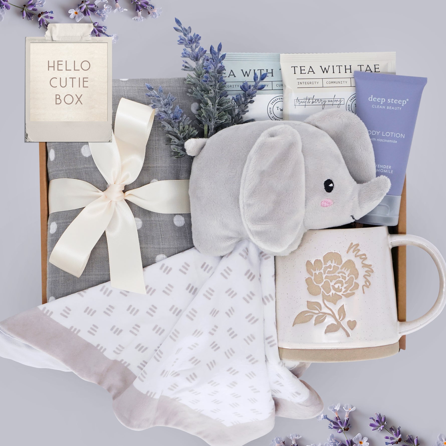 Hello Cutie Wildflower Pop New Baby and New Mama gift box comes with a grey polka dot cotton swaddle, Elephant love, tea sampler, deep steep lavender lotion, and Wildflower Pop ceramic mama mug