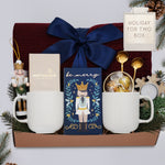 Wildflower Pop Holiday for Two Blanket Gift Box, with Burgundy cable knit blanket, chocolate bar, nutcracker ornament, drink sampler, truffle assortment, 2 gold demitasse spoons, 2 cream ceramic mugs, and snowflake votive 