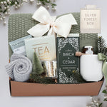 Wildflower Pop Silver Forest Blanket gift box, with sage green lace knit blanket, cream ribbed ceramic mug, grey cozy boot socks, silver votive and tea light, mini honey and dipper, silver birch and cedar shower steamers, and tea sampler