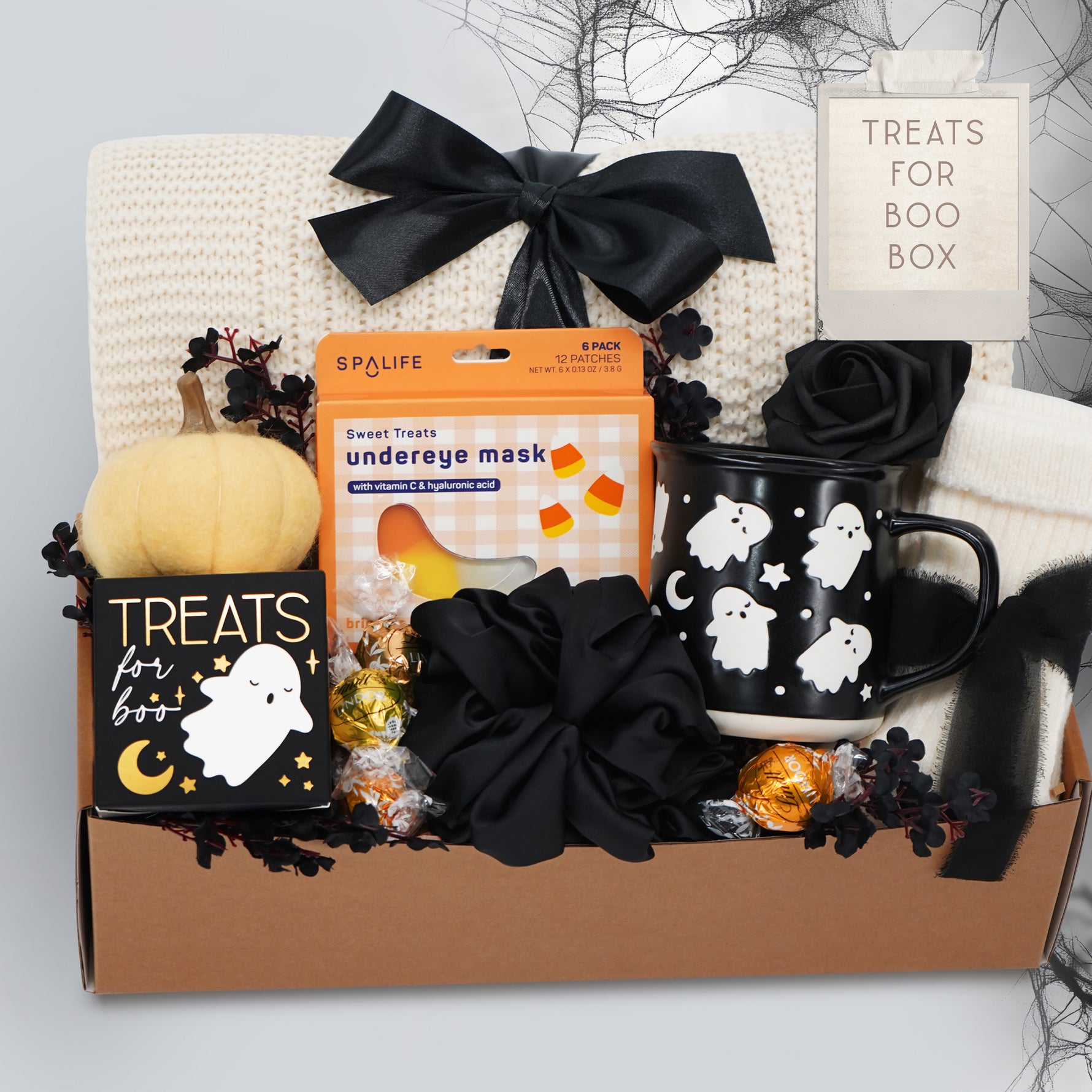 Wildflower Pop Halloween-themed boo basket with an exclusive ghost mug, candy, and decorative items on a white background.