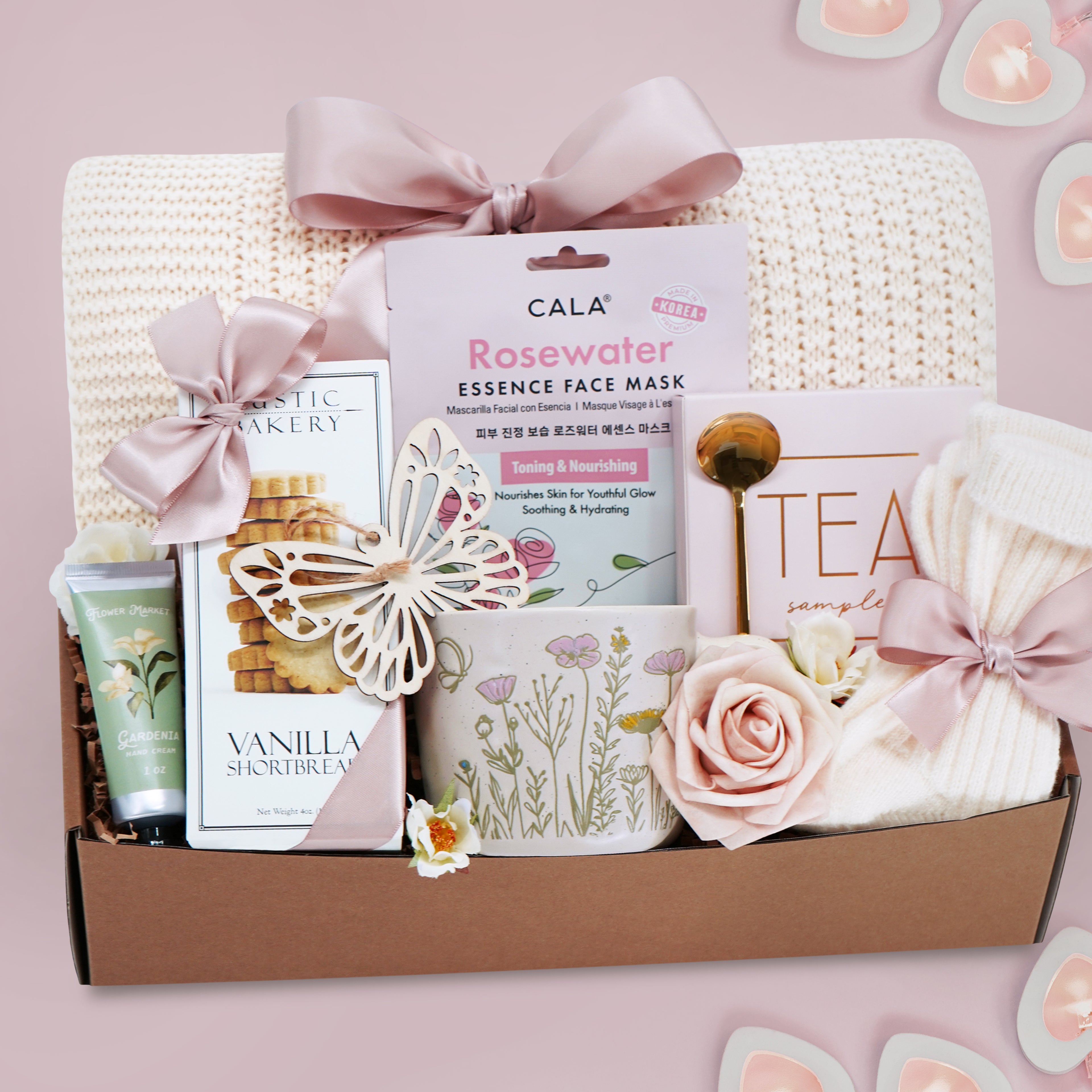 Wildflower Pop wildflower meadow blanket gift box with a cream lace knit blanket, Rosewater face mask, gold spoon, tea sampler, cream knit socks, faux rose, wildflower ceramic mug, wood butterfly ornament, Rustic bakery vanilla shortbread, Flower Market gardenia hand lotion 